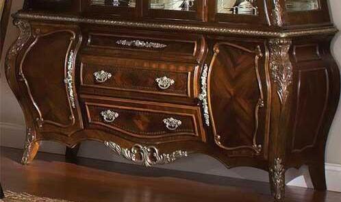 Decorative wooden dresser with intricate carvings and reflective surface