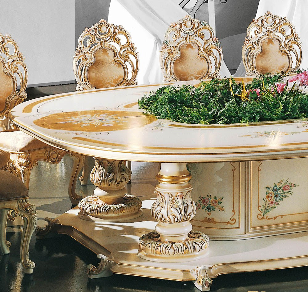 Decorative table with ornate chairs and floral arrangement in a formal setting
