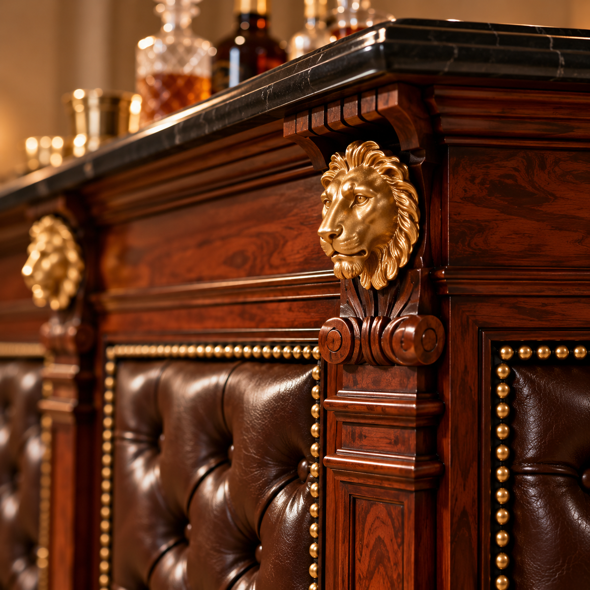 Close-up of an ornate bar cabinet with dark wood paneling, a black marble countertop, tufted brown leather seating, brass nailhead trim, and gold lion head sculptures on the front.
