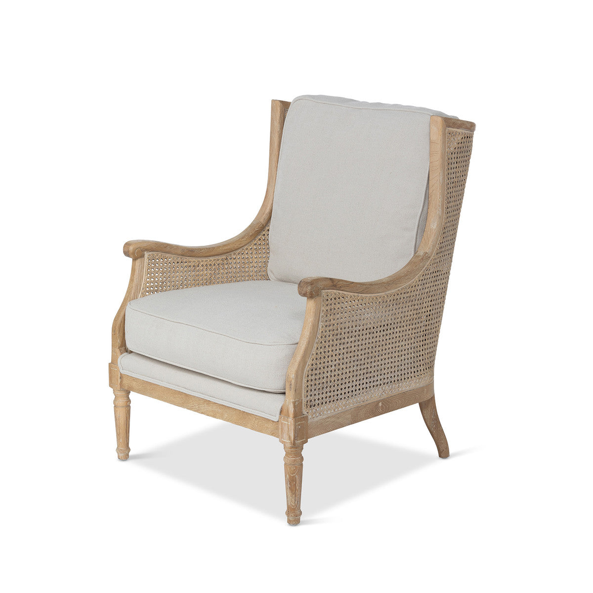 A beige Sidqa Provence Cane Armchair with a beige cushion and a distressed natural wooden frame.