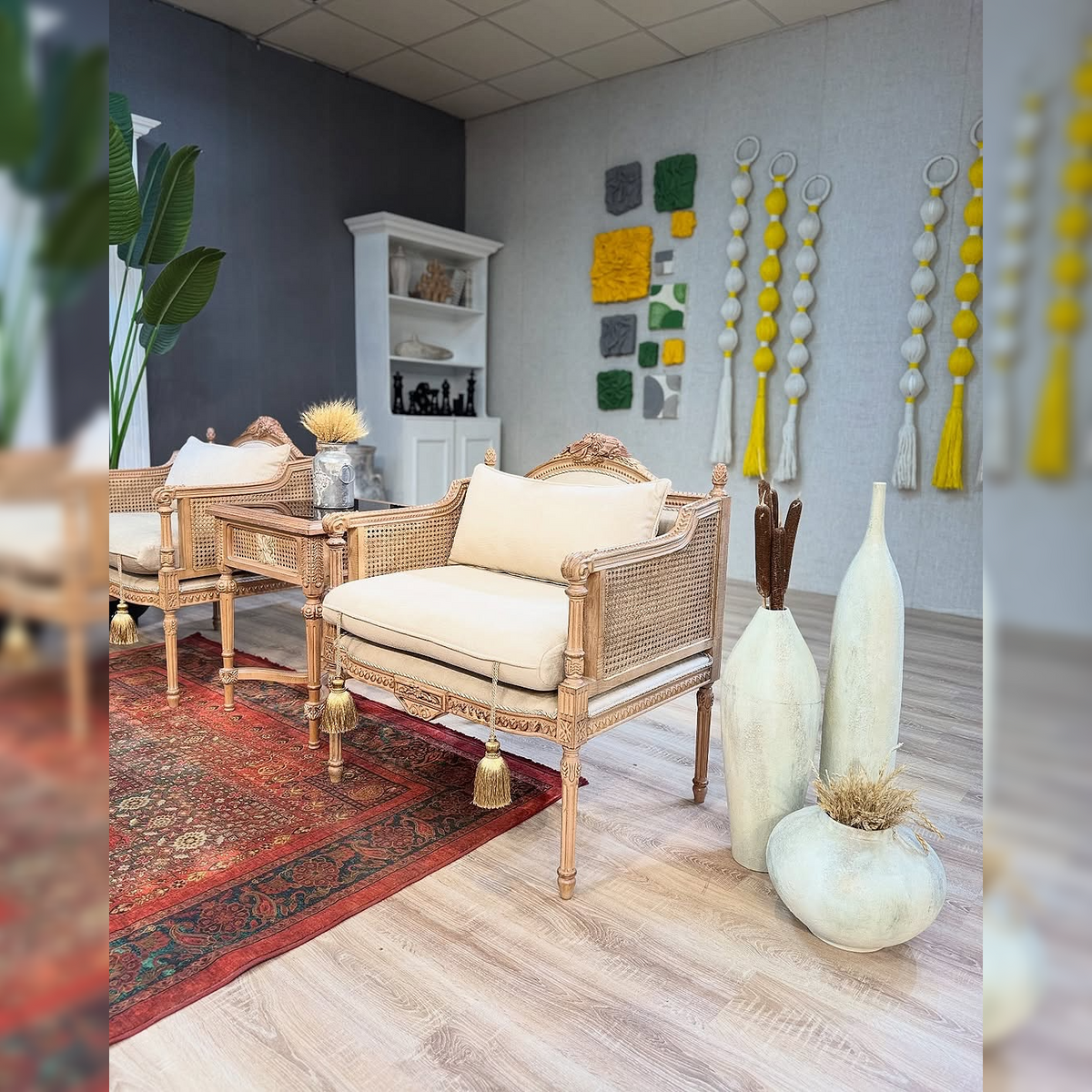 Living room with wicker furniture, decorative vases, and wall art.
