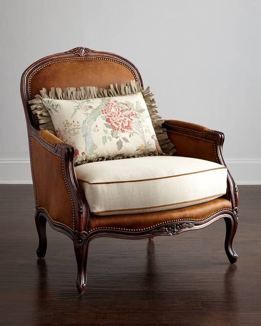 Vintage-style armchair with decorative pillows on a wooden floor.