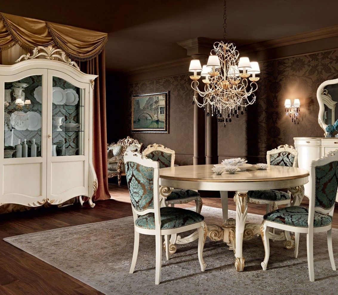 Dining room with round table and ornate chairs in a classic setting.