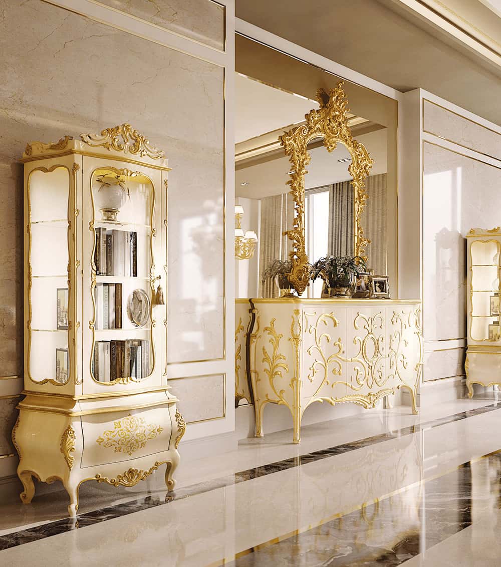 Luxurious interior with ornate gold furniture and mirror in a marble-floored room.