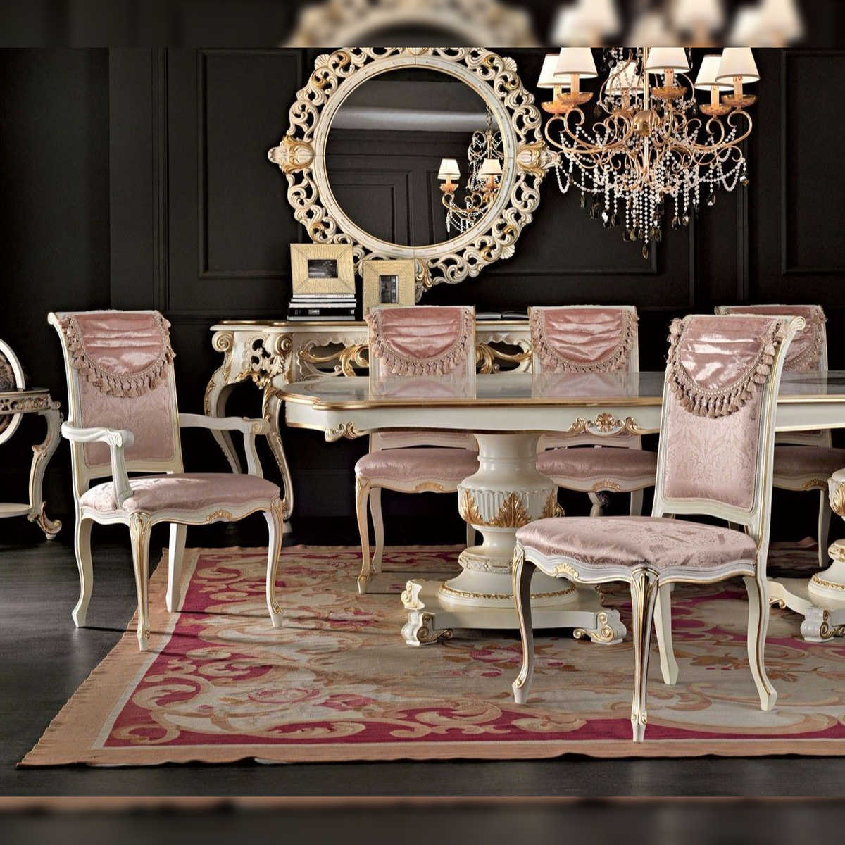 Dining room with ornate table, chairs, and chandelier in a dark room.