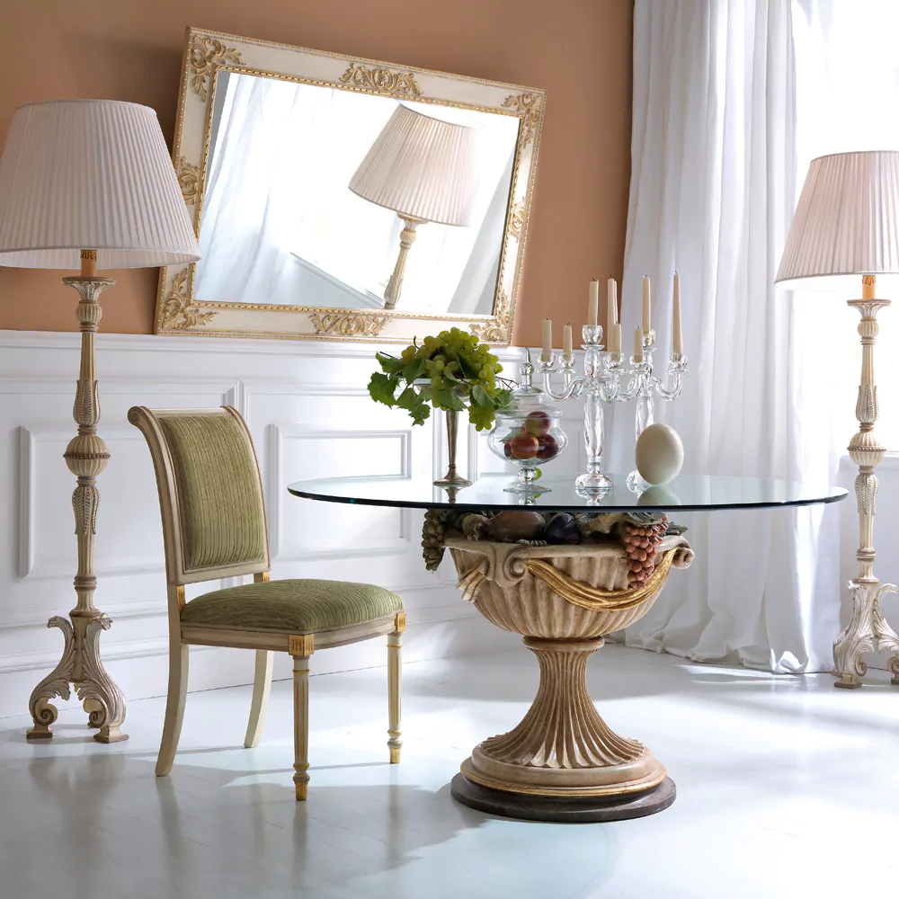 Dining room with ornate table, chair, and decorative elements.