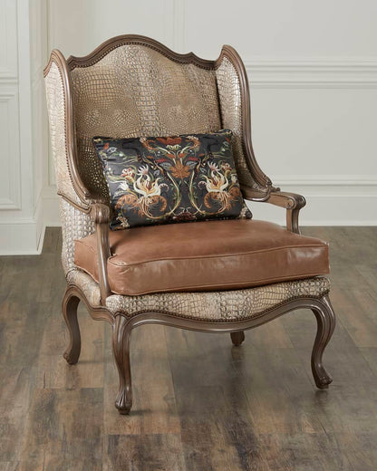 Decorative armchair with patterned backrest and brown leather seat on a wooden floor.