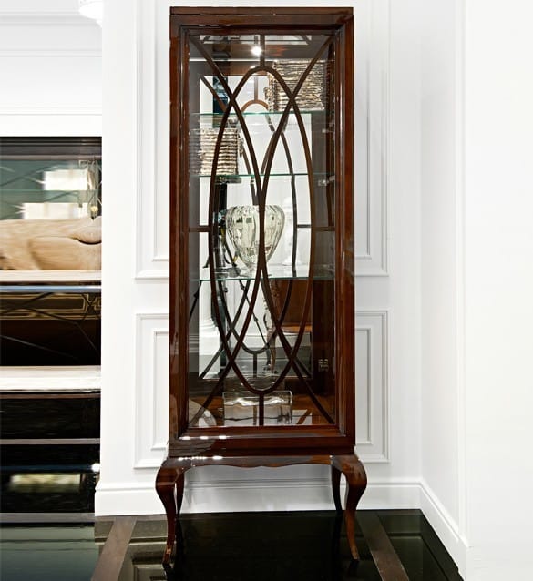 A brown display cabinet with glass shelves and mahogany feet, featuring a sophisticated design suitable for living rooms or dining rooms.