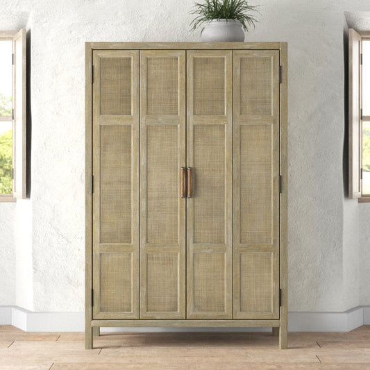 A wooden cabinet with tall doors paneled in handwoven cane, with a weathered finish and metal handles.
