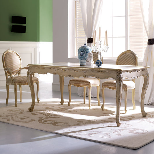 Dining room with a decorative table and chairs in a bright room.