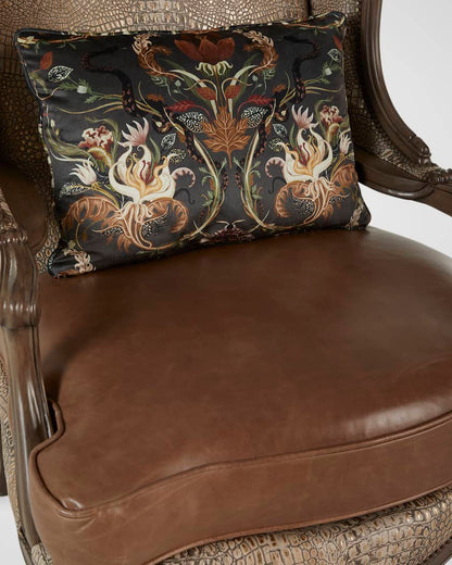 Decorative pillow with floral pattern on a brown leather chair