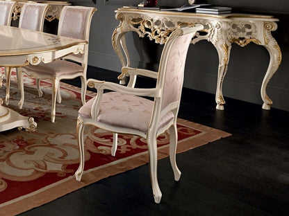 Decorative dining table and chairs with intricate designs in a room.