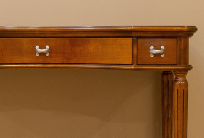 Wooden console table with two drawers against a beige wall