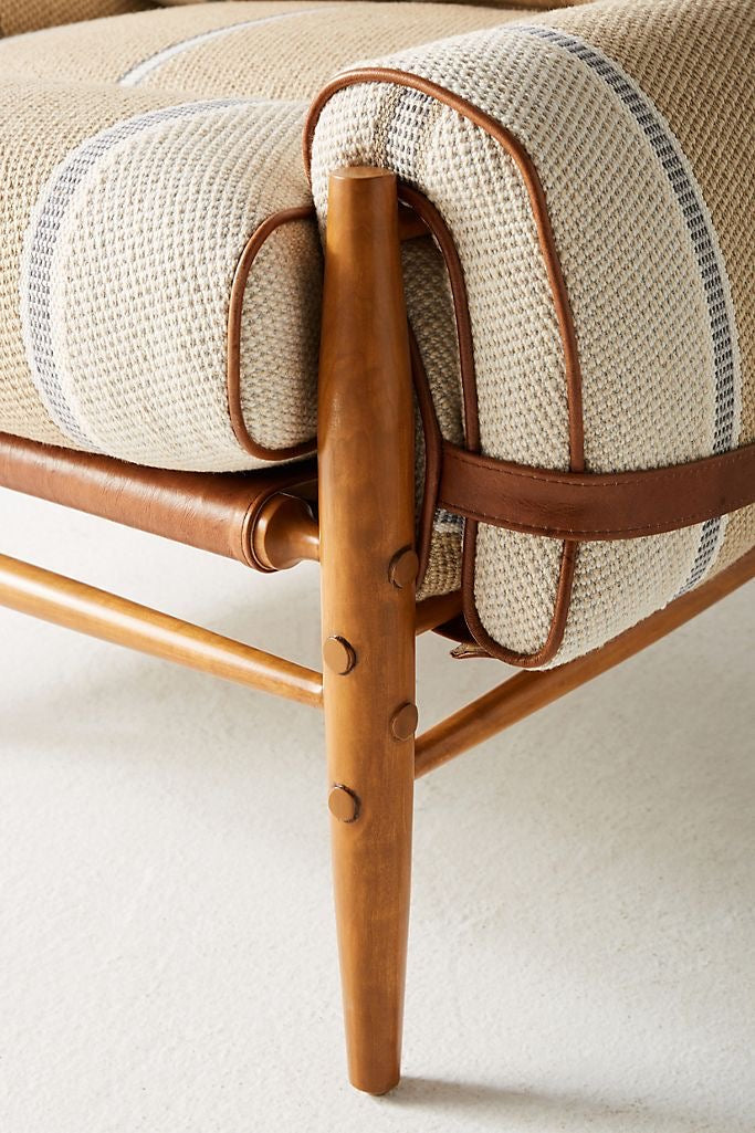 Close-up of a wooden chair with woven seat and backrest on a light background