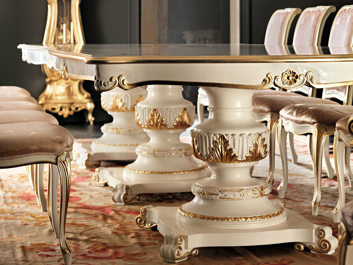 Decorative dining table with ornate legs and chairs in a room setting.