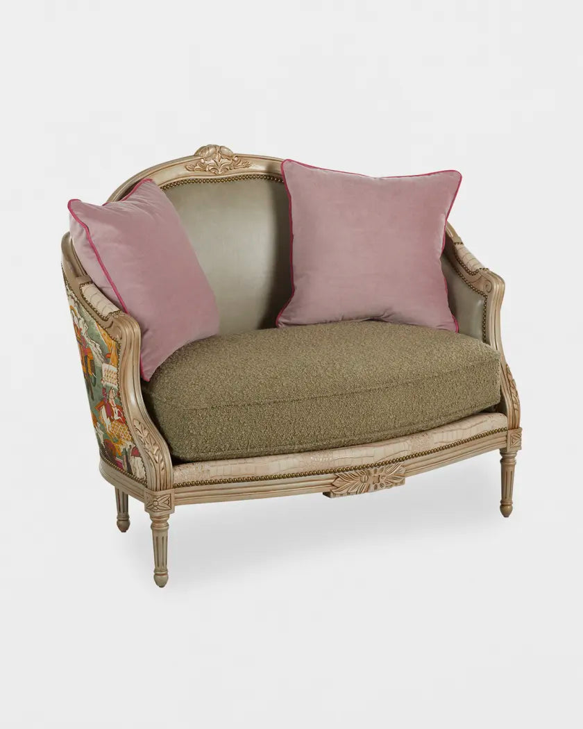 Vintage-style loveseat with pink cushions on a white background