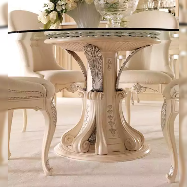 Decorative dining table with intricate designs in a softly lit room.