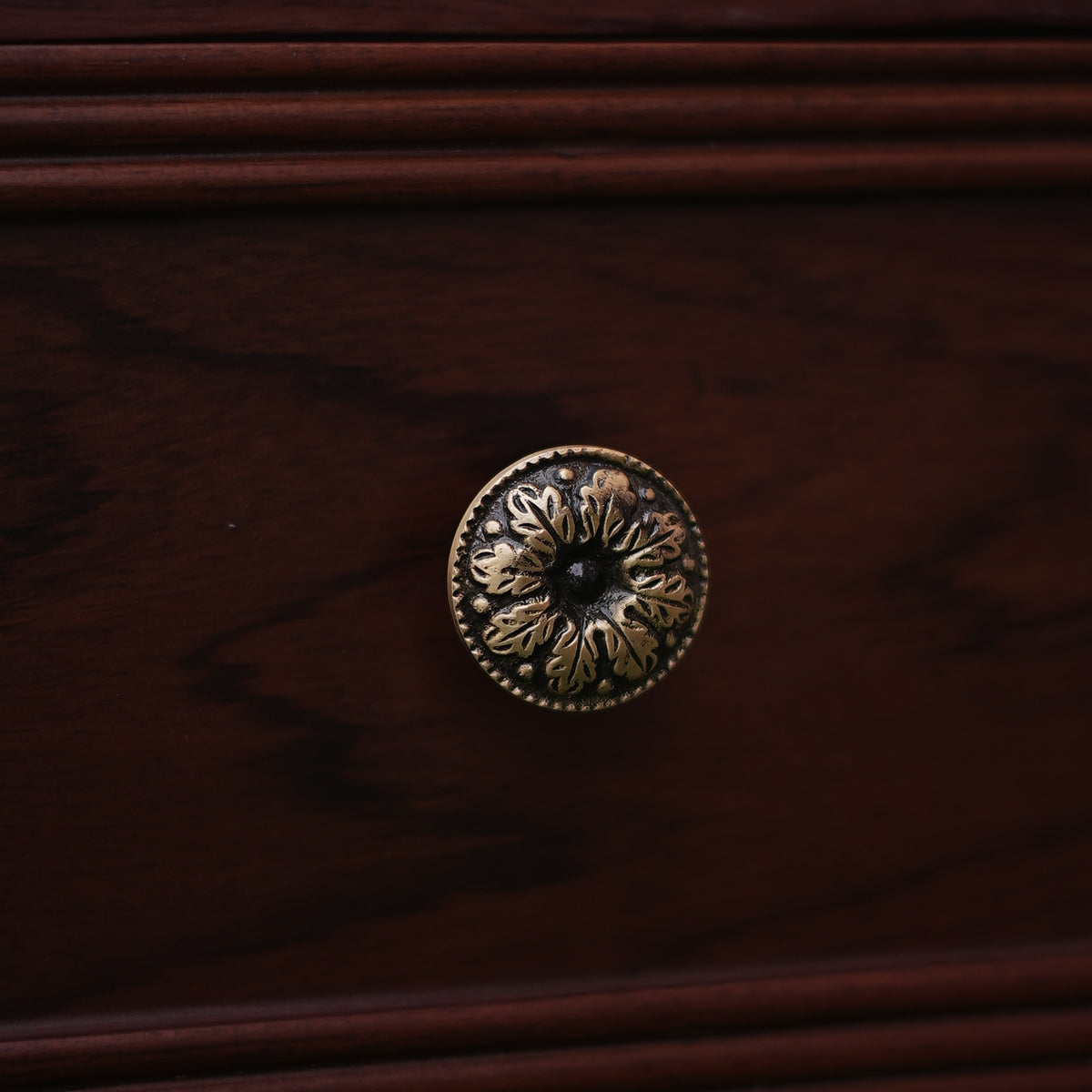Decorative brass doorknob on a wooden door