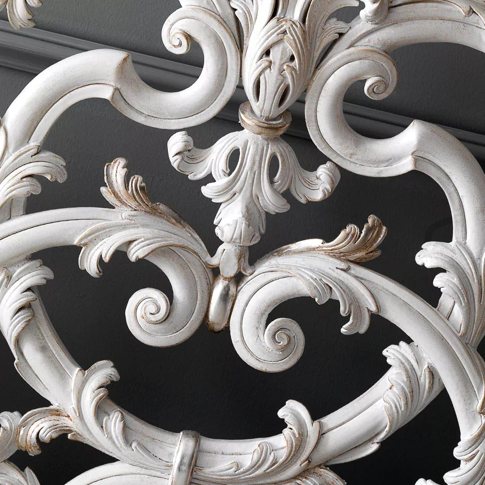 Close-up of ornate white decorative molding against a dark background