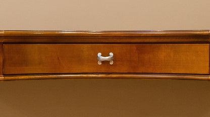Wooden drawer with a metal handle on a beige background