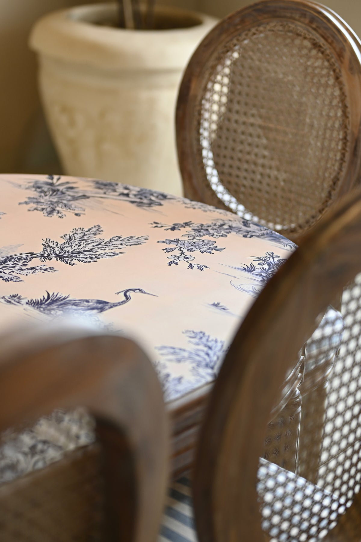 Chair with a floral cushion and wicker backrest