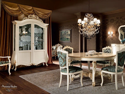 Elegant dining room with a large white armoire, chandelier, and table set.