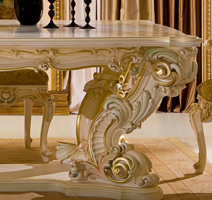 Decorative table with intricate gold carvings in a room with ornate decor.
