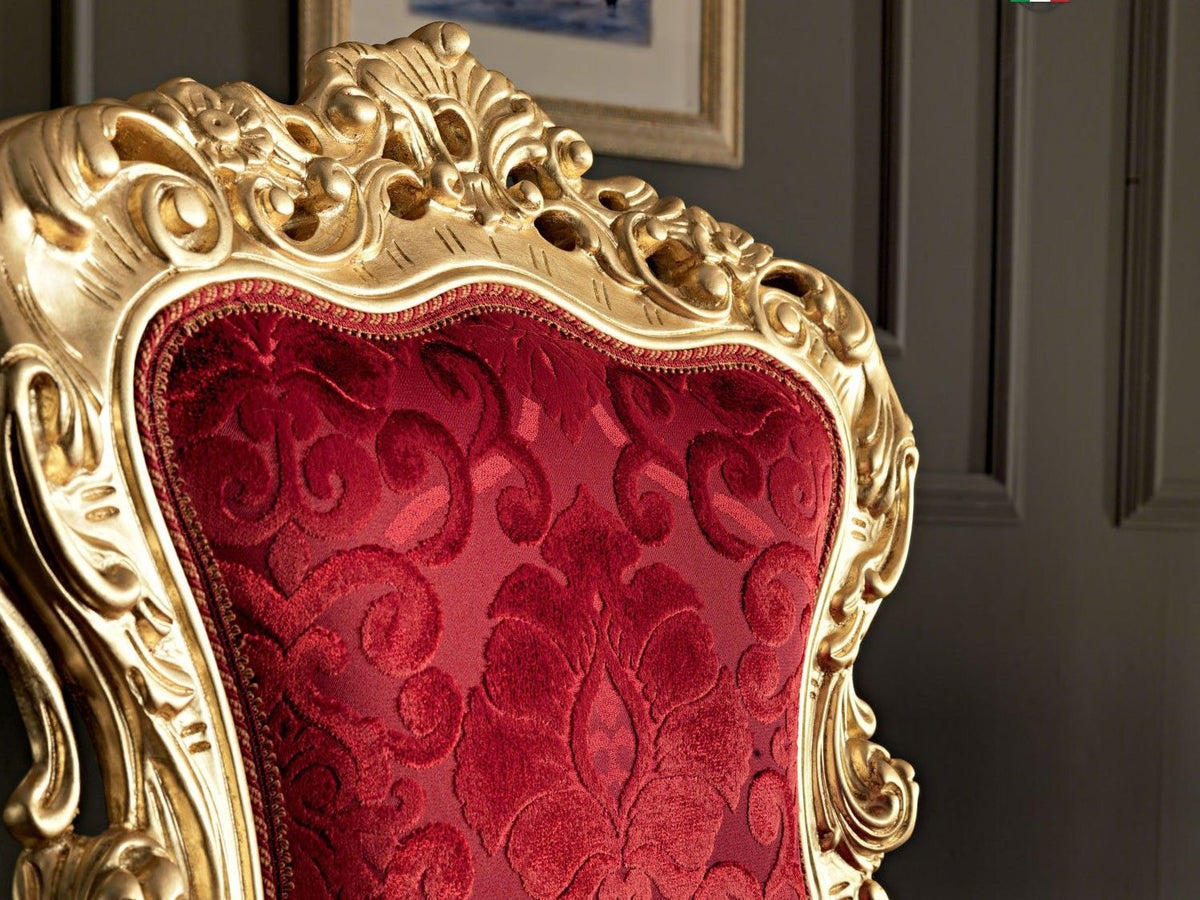 Decorative chair with gold frame and red fabric in a room setting