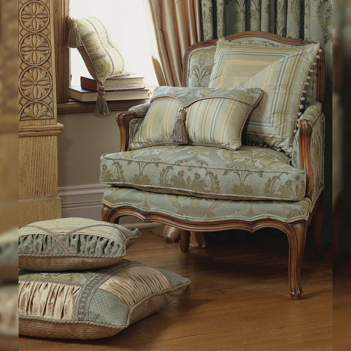 Decorative armchair with patterned cushions in a room with wooden floor and ornate wall.