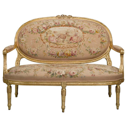 An ornate, floral-patterned jacquard fabric sofa with antique gold detailing and a carved wooden frame.