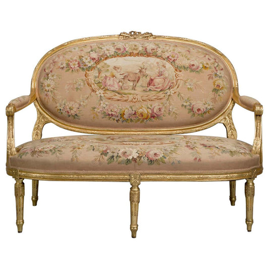 An ornate, floral-patterned jacquard fabric sofa with antique gold detailing and a carved wooden frame.