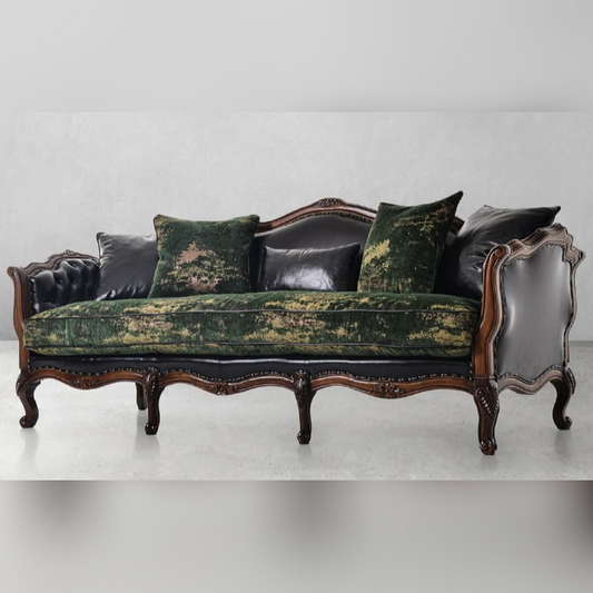 Vintage-style sofa with green velvet and black leather accents on a white background