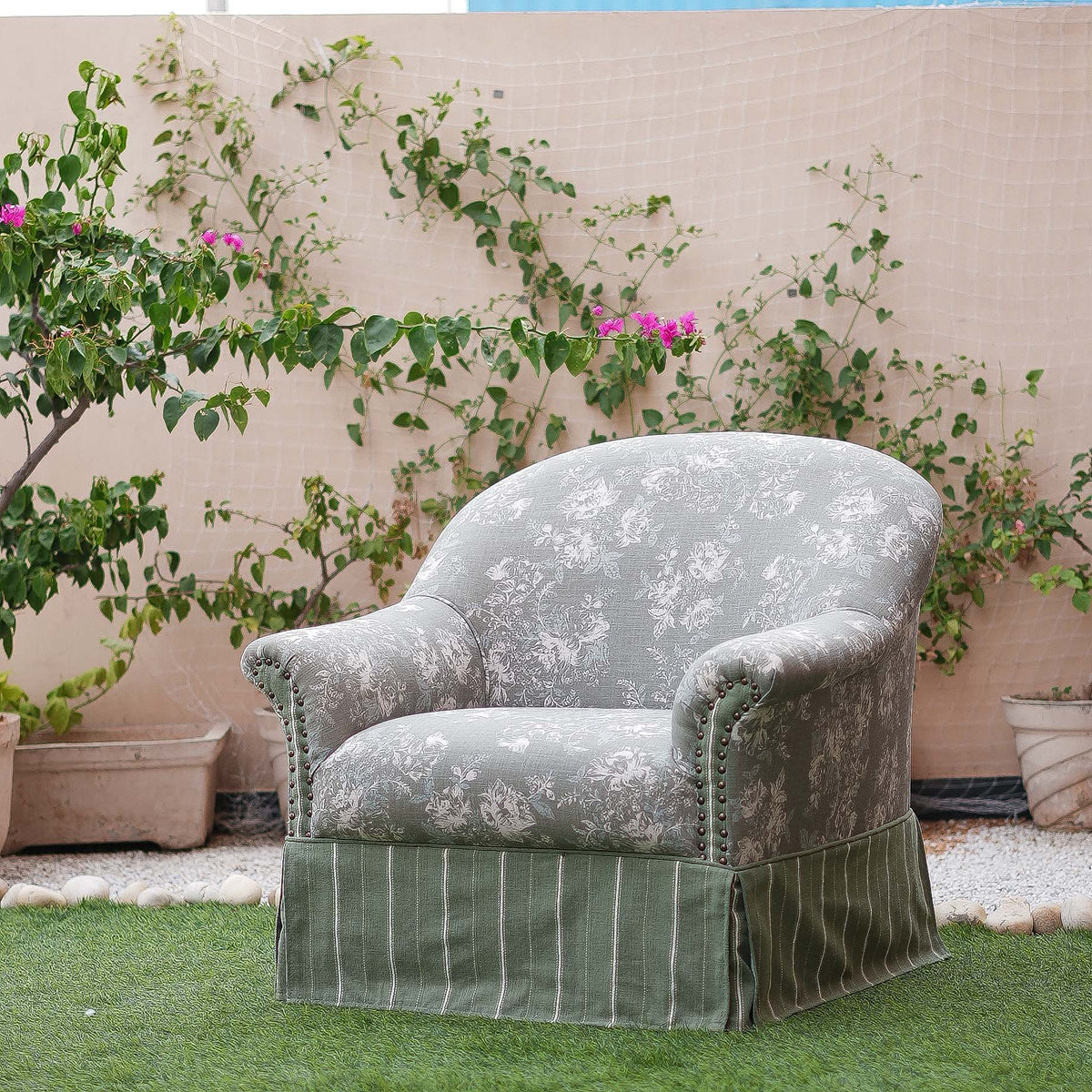 Decorative armchair with floral pattern in a garden setting