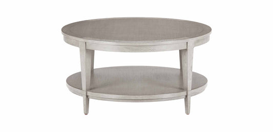 A round, French distressed double-decker coffee table with a gray finish and a lower shelf, made of bamboo wood.