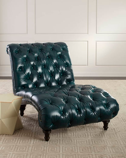 Green leather tufted chair in a room with white paneled walls and a patterned rug.