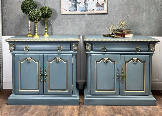 Pair of blue sideboards with decorative elements on a wooden floor.