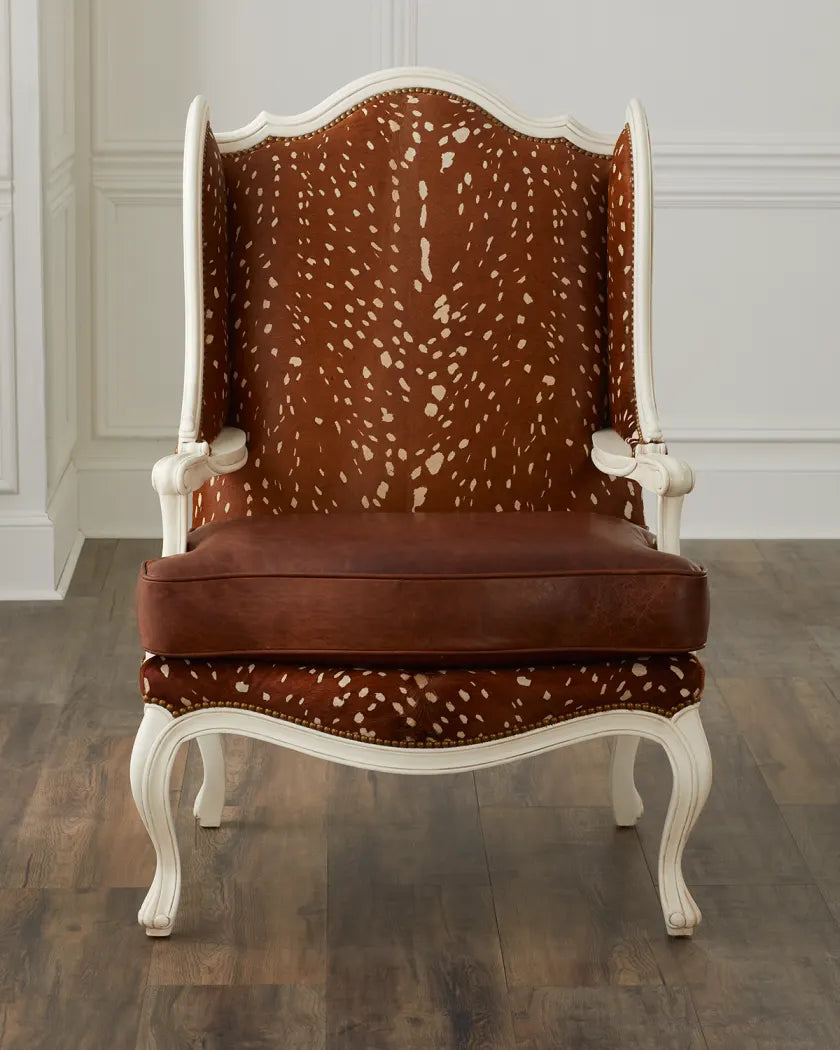 Chair with brown and white patterned backrest and seat on a wooden floor.