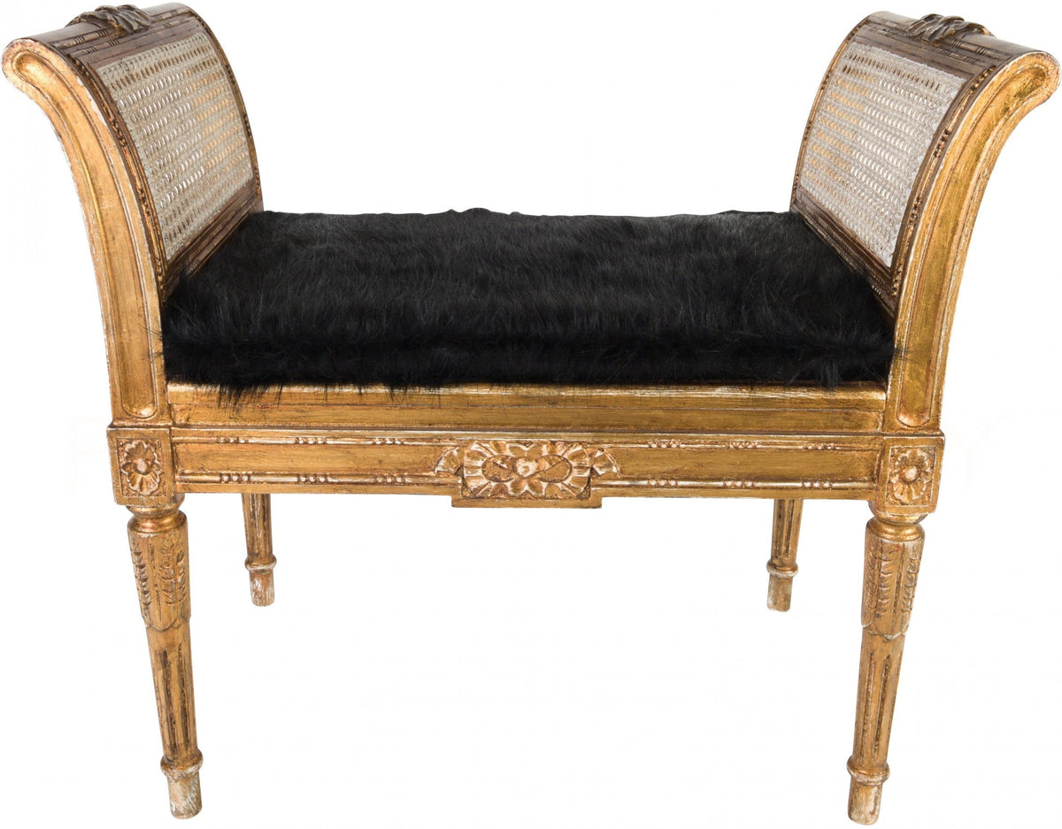 Antique gold finish bench with intricate cane work on the sides and a black upholstered seat