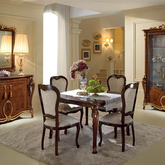 Dining room with wooden table and chairs, decorative elements, and a mirror.