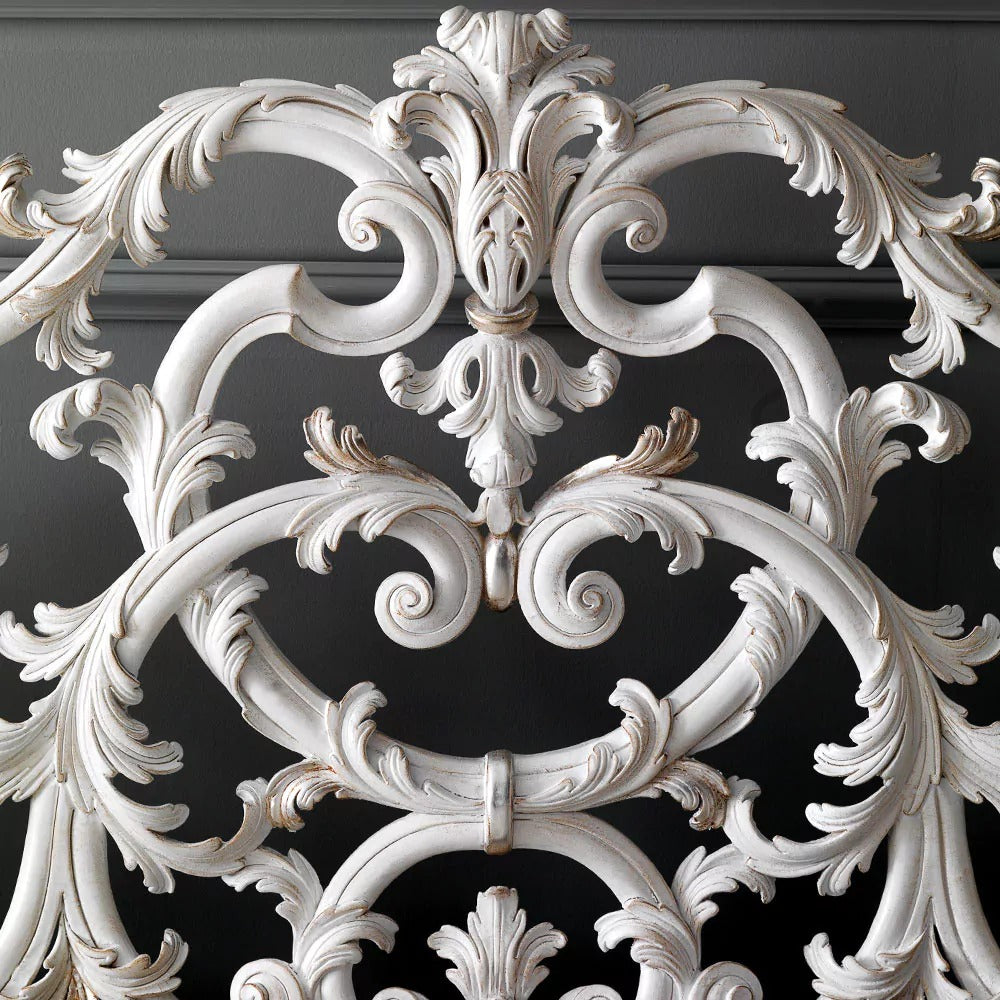 Decorative white metal grille on a dark background