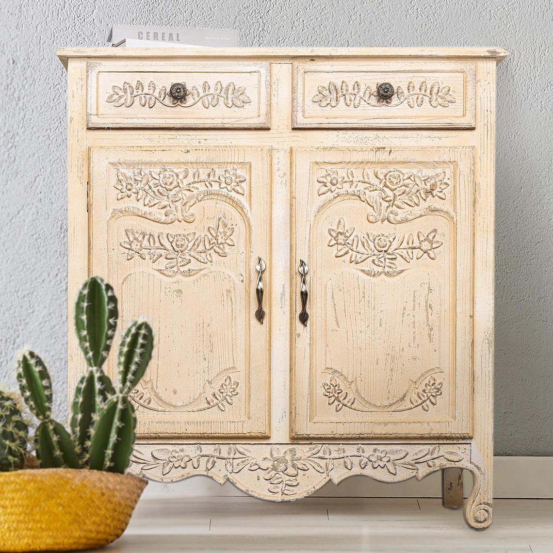Decorative wooden cabinet with floral carvings on a gray background