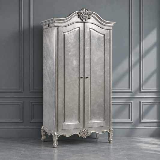 A tall, ornate silver armoire cabinet with two doors, decorative carved details, and curved top, shown against a gray paneled wall.