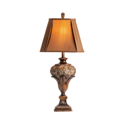 An elegant table lamp with a pleated shade, featuring a bronze-colored base with decorative elements and a warm light illumination.