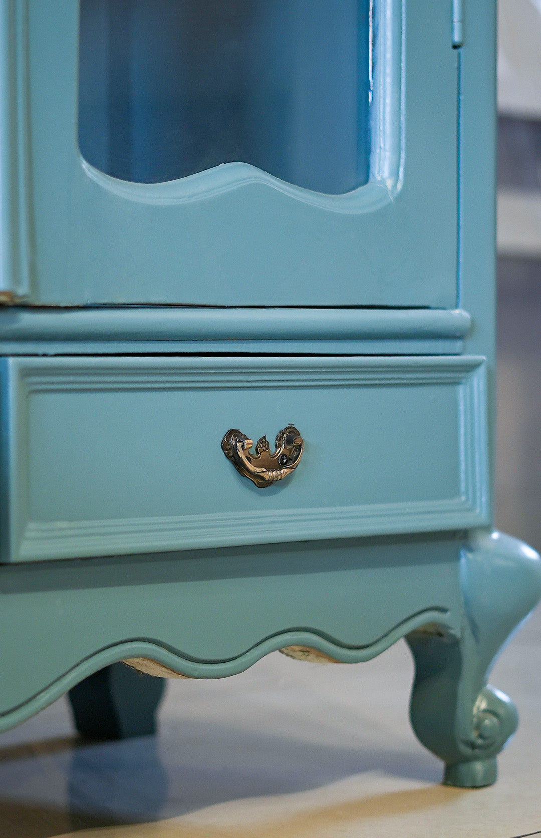 Light blue vintage-style cabinet with a drawer and decorative handle.