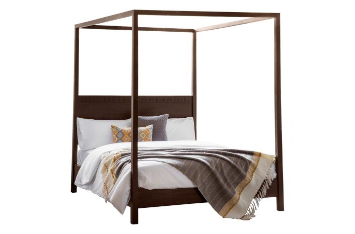 Four-poster bed with bedding and pillows on a white background