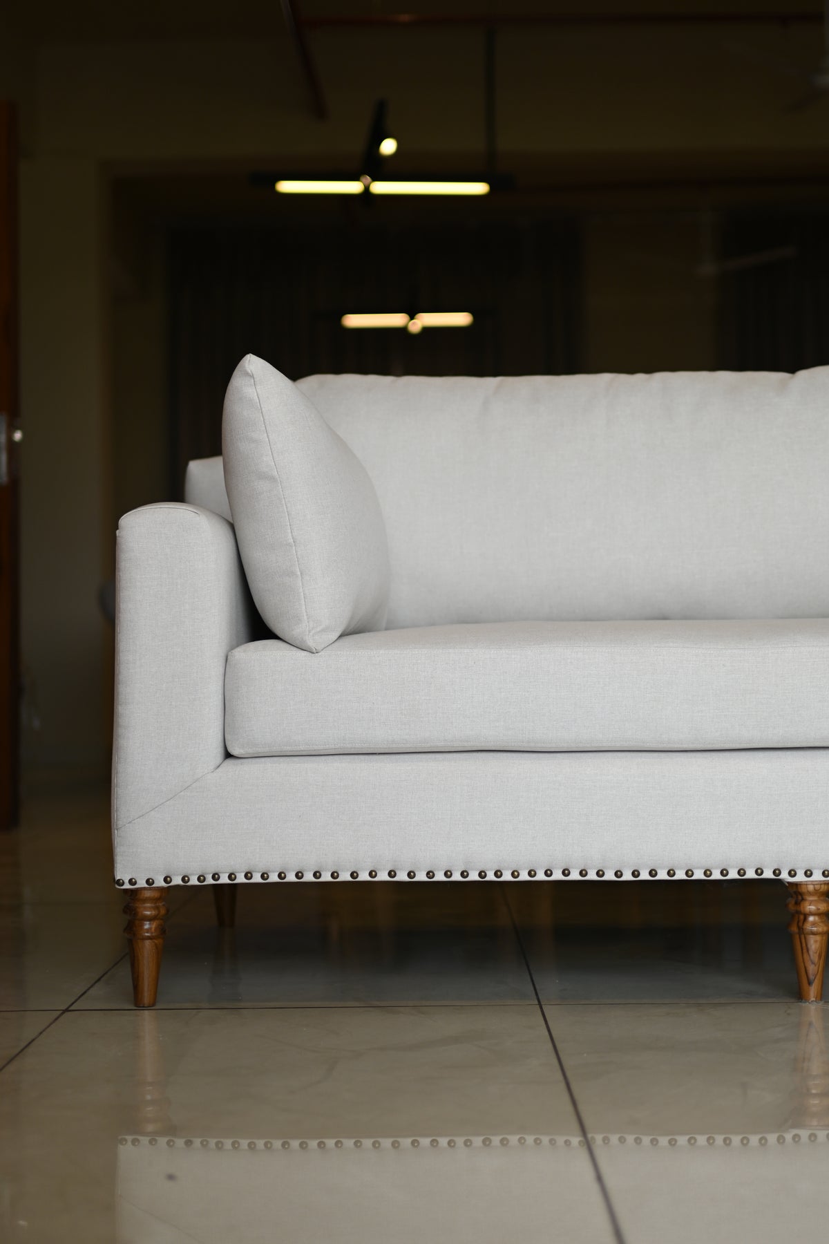 Gray upholstered chair with a blurred background