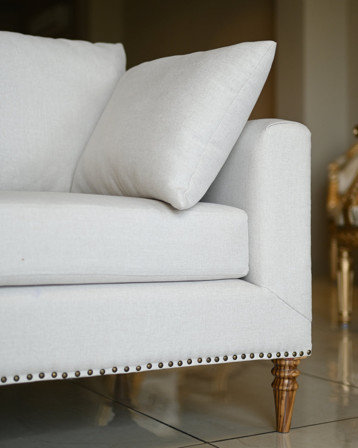 Light gray sofa with wooden legs in a room setting