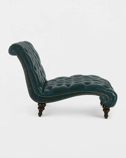 Green tufted chaise lounge on a white background
