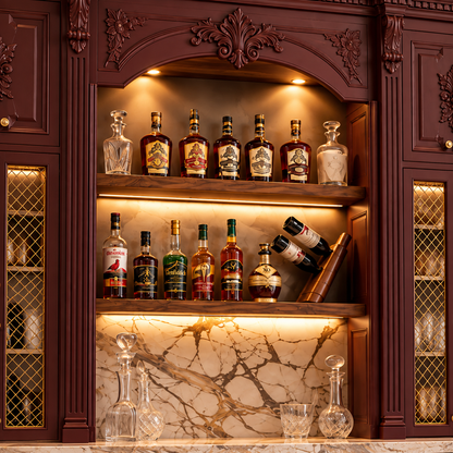 An ornate dark wood built-in bar cabinet with illuminated shelves, marble backsplash, and multiple liquor bottles and glass decanters displayed inside.