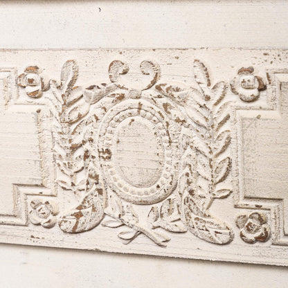 Decorative architectural detail with intricate patterns on a light background